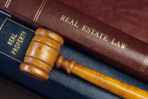 Real estate books with a gavel laying on top