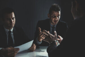 Client sitting with criminal defense attorney