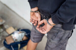 Man caught in burglary, in handcuffs